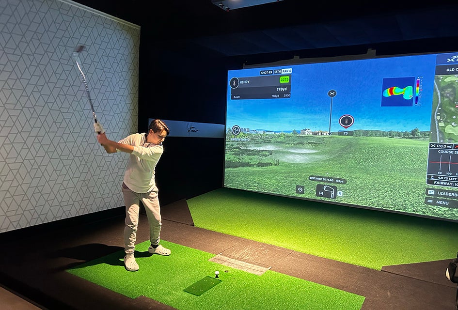  Golf simulators at X Golf in the Samanea Mall allow players to practice their swing. Photo by the author