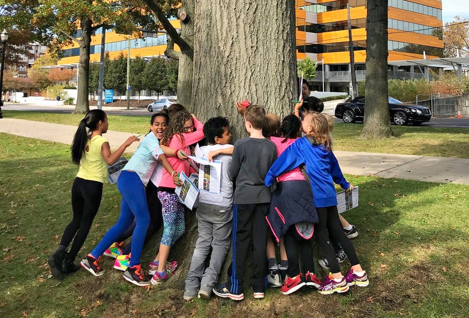 Kids bond with trees—and one another—at the Mill River Park Scavenger Hunt. Photo courtesy of Mill River Park Collaborative