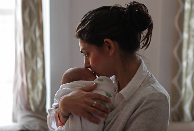 a mother cradles a newborn baby