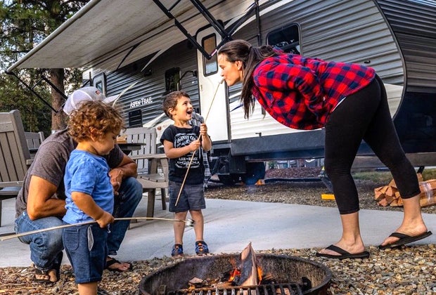 Photo of a family around a campfire - End of Summer Bucket List