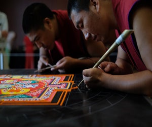 Watch the skill and precision of the Mandala Sand Painting artists at work. Photo courtesy of Asia Society of Texas.