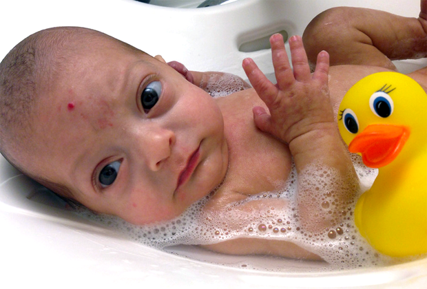 young baby in a baby bath