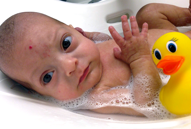 young baby in a baby bath