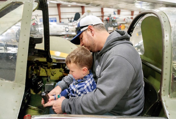 Image of father and son in a plane cockpit - Fall Bucket List for Kids
