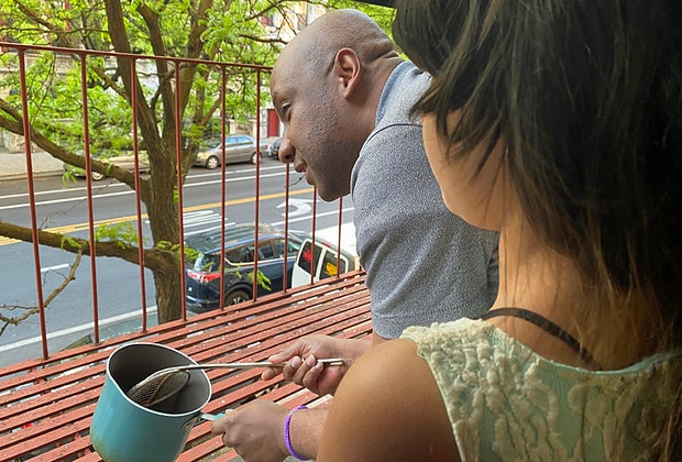 A father and daughter cheer during New York City's 7pm clap