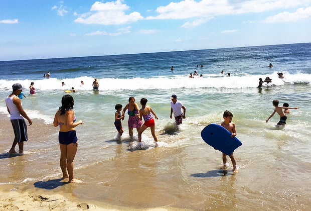People on the beach in the sand and waves