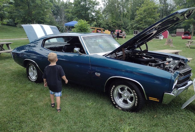 Little boy looks at a classic car at DuBois Farms
