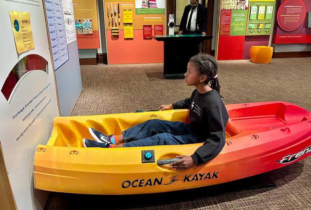 National Museum of the American Indian: girl trying a kayak balancing activity