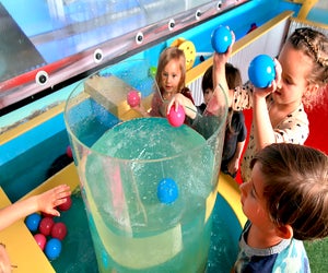 Twinkle Playspace's water table let’s kids toss objects into its whirlpool.