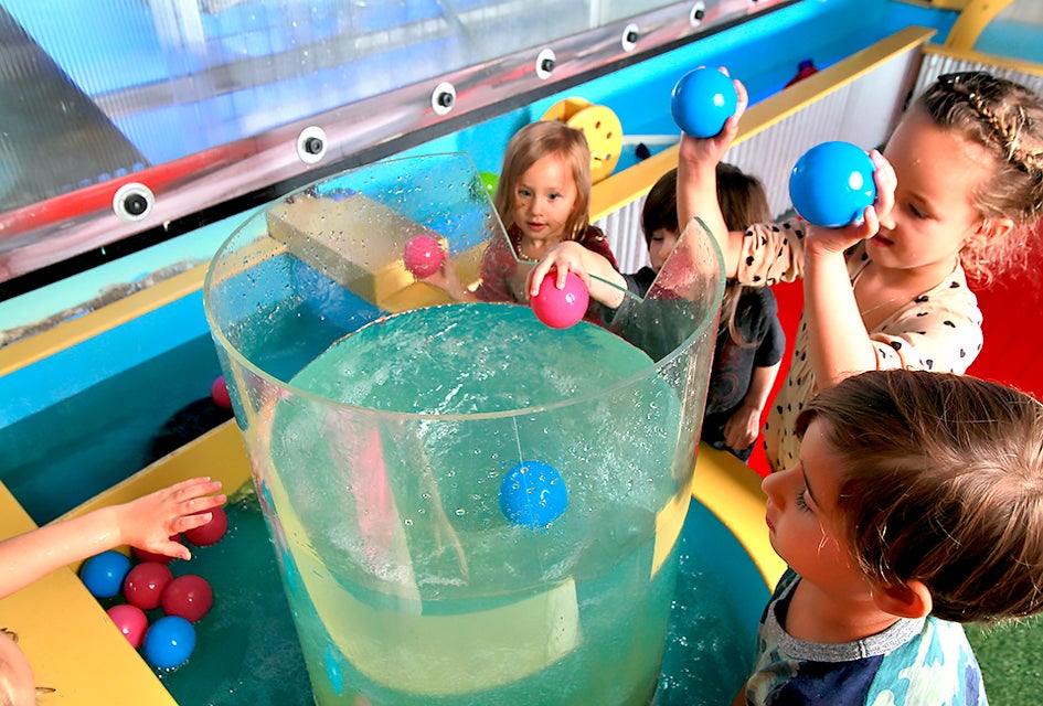 Twinkle Playspace's water table let’s kids toss objects into its whirlpool.