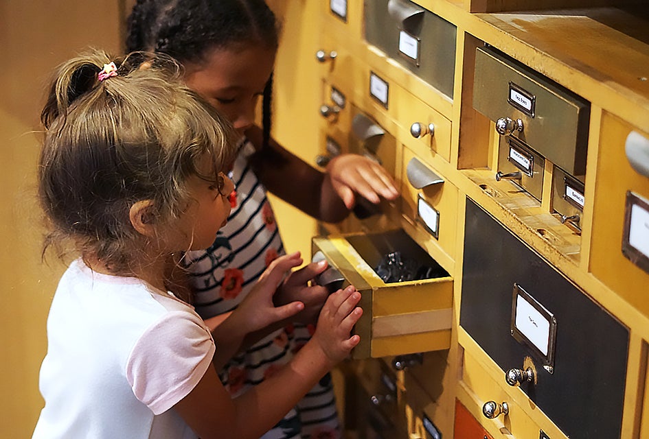 Members of The Discovery Squad at AMNH get hands-on time in the Discovery Room. Photo by Jody Mercier