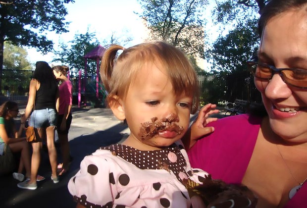Best things to do in NYC with babies: First birthday party baby with messy, cake-covered face
