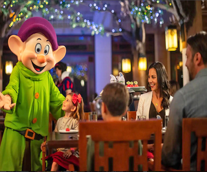 Celebrate your child’s birthday with Snow White, Dopey, and Grumpy at Story Book Dining at Artist Point. Photo courtesy of Disney