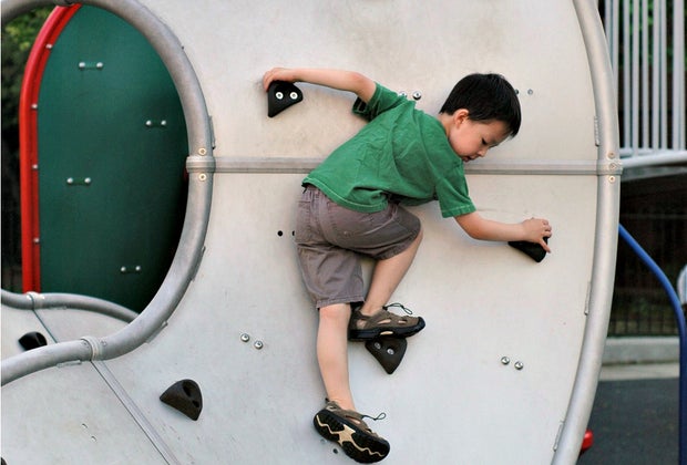 Image of toddler climbing at Peters Park playground in Boston.