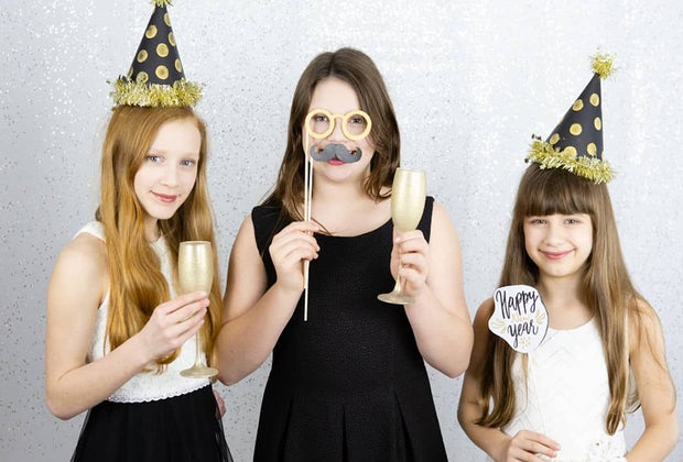 New Year's Eve costumes and photo booths are a great way to celebrate at home with kids.
