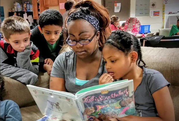 Image of adult reading to children at after school program in Boston.