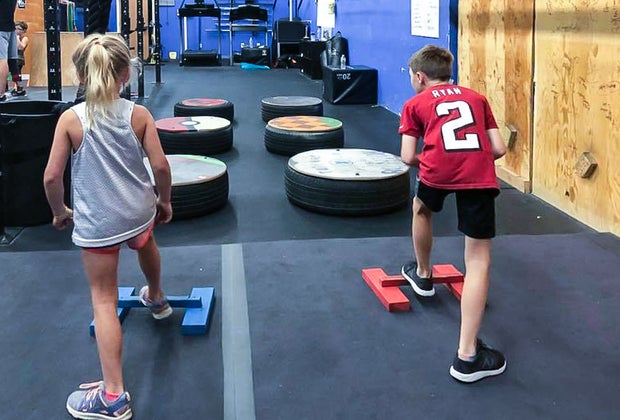 Photo of kids at a ninja warrior obstacle course near Boston.