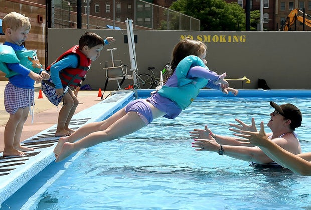 Image of small child diving into Boston swimming pool.