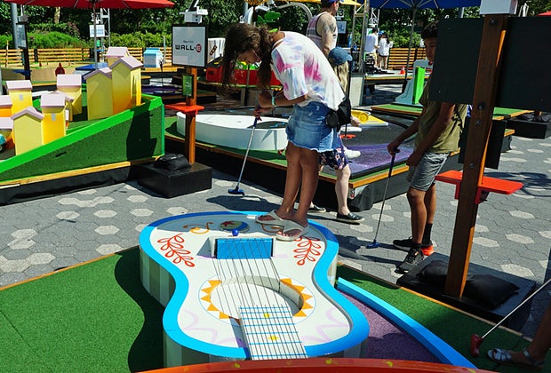 Girl plays Pixar Putt Coco hole