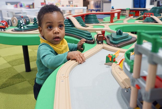 Play Street Museum: Toddler plays at a train table