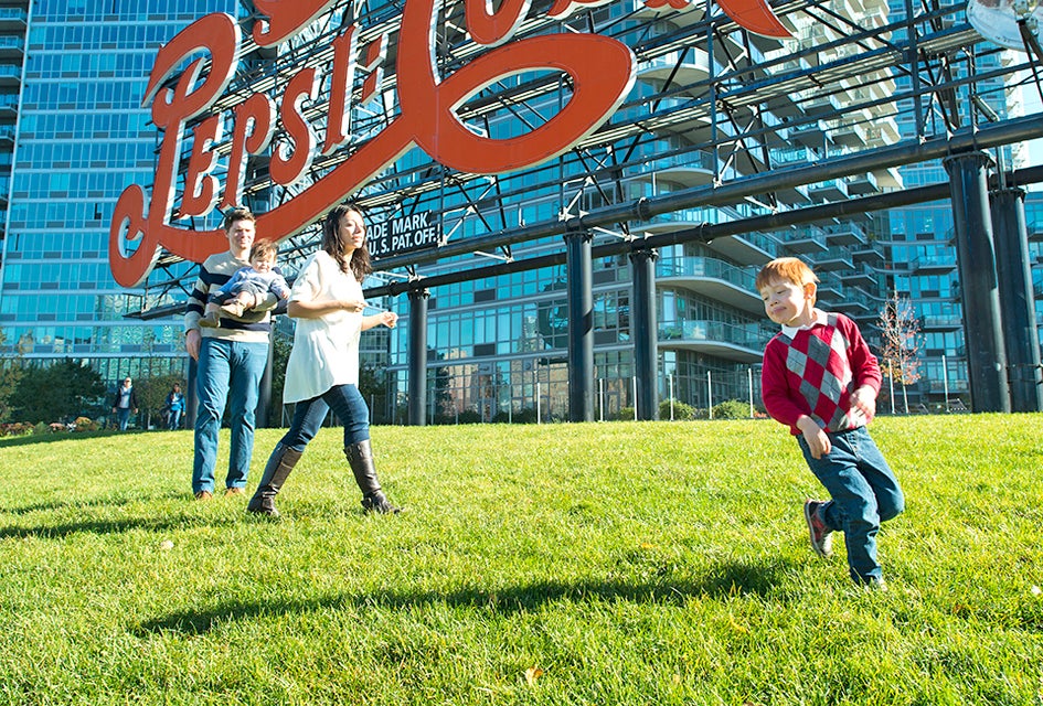 Play under the  iconic Pepsi Cola sign. Photo by Sidney Ng