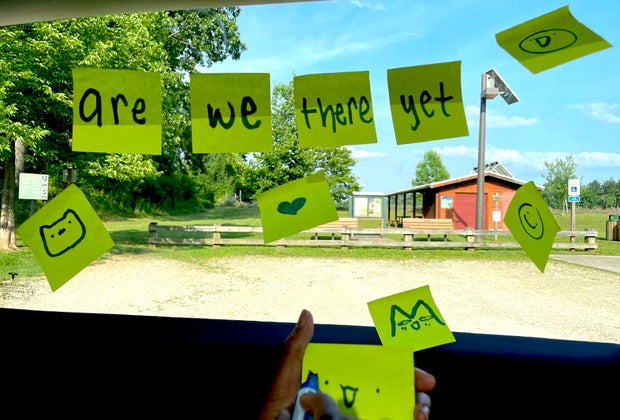 Post- its in a car window spelling are we there yet?