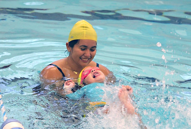 swim instructor in the pool with a toddler swim class
