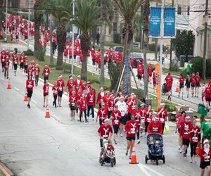 Watch thousands of Santas take to the street during this holiday race. Photo courtesy of Santa Hustle Race Series, LLC.