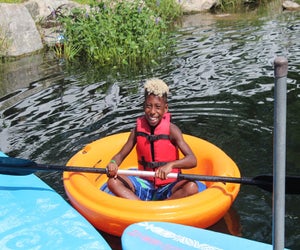  Spring Lake Day Camp has a 5-acre lake for boating, fishing, and water slides. Photo courtesy of the camp