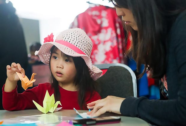 child learning origami