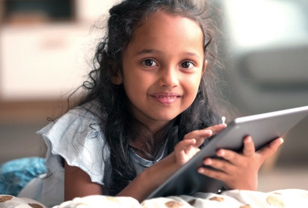 Go ahead. Hand them the iPad; these websites for kids are fun and at least a little educational. Photo courtesy of Bigstock