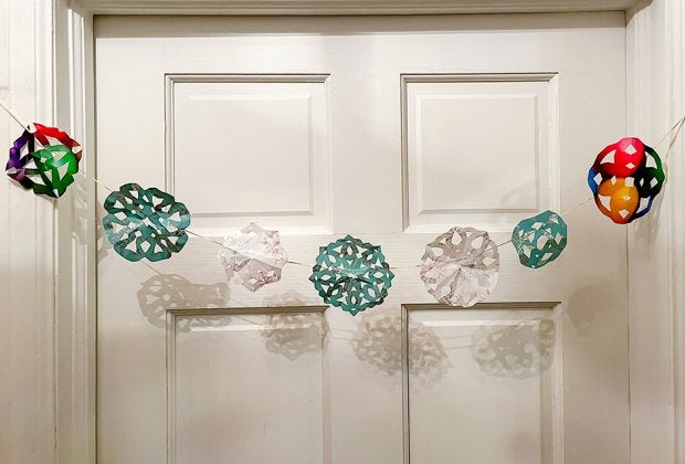 Making paper snowflakes from recycled wrapping paper is easy and fun for kids. Photo by the author