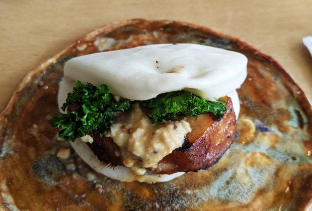 Shuya Cafe de Ramen's take on a classic bao bun features an extra-thick slice of glazed pork belly.