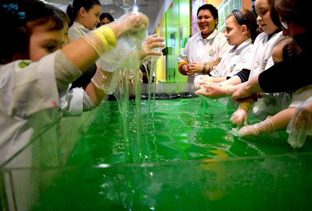 The Slime Factory experience includes time to play in a giant vat of green slime!