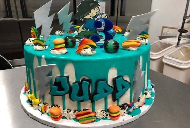 At Armonk's Sugar Hi, specialty cakes include a brightly-colored ganache drip with candy pieces. Photo courtesy of Sugar Hi