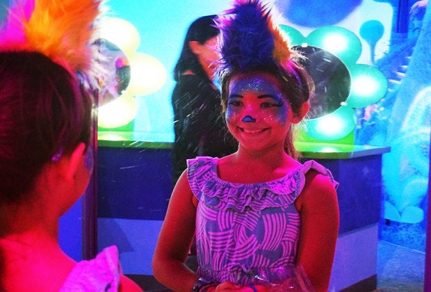 The smile proves that the Trolls Experience can deliver your "best day ever."