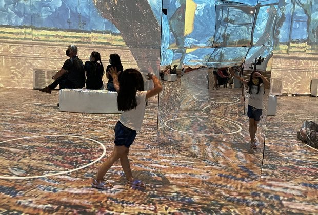 Mirrors put kids right in the middle of the art at Immersive  Van Gogh. Photo by Maureen Wilkey 