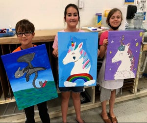 Kids display their artworks from class. Photo courtesy of Sugar Land Art Gallery.