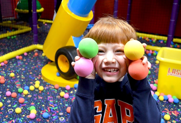 Boy in a ball pit at Laser Bounce, one of our favorite trampoline parks in NYC