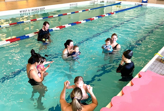 parents and babies in pool swim class