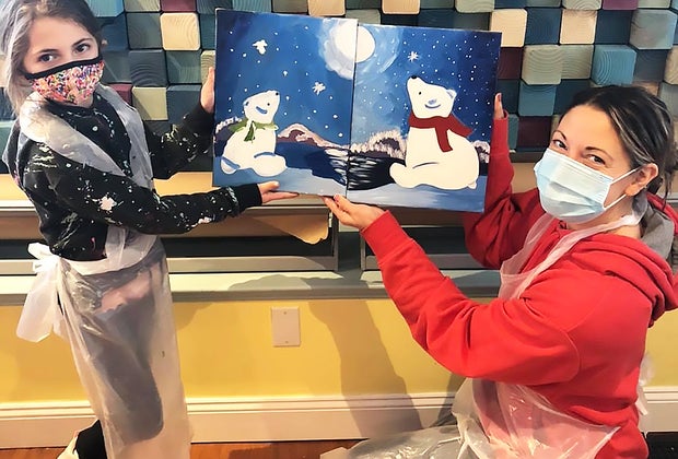 Girl and mom with artwork at The Pottery Factory