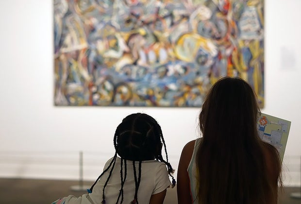 Two girls look at a Jackson Pollock at The Met one of our favorite tourist attractions in NYC