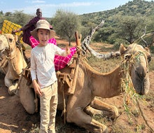 Embrace the slow rhythm of a camel ride on a safari adventure. Photo by Diana Kim