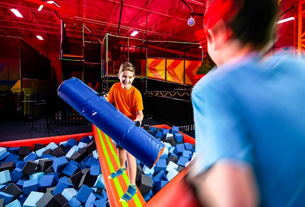 Image of kids at battle beam pit at Urban Air Trampoline Park in CT