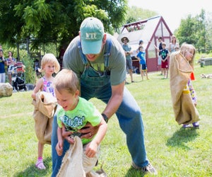 Jump into a potato sack race at Wakeman Town Farm Family Fun Day. Photo by Peter LaMastro
