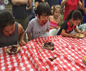 The pie eating contest is just the start of the fun at the Armonk Cider and Donut Festival. Photo courtesy of the festival