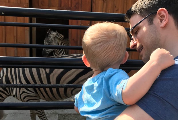Boy and dad looking at zebras at White Post Animal Farm on Long Island