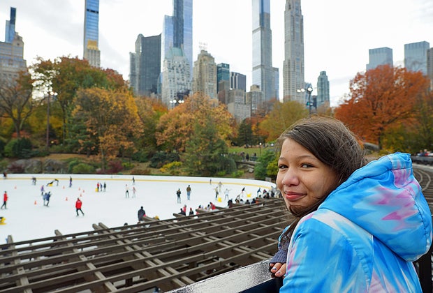 View overlooking Wollman Rink with NYC skyline behind it.