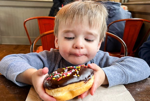 Photo of a child with a donut - Train Rides for Connecticut Kids